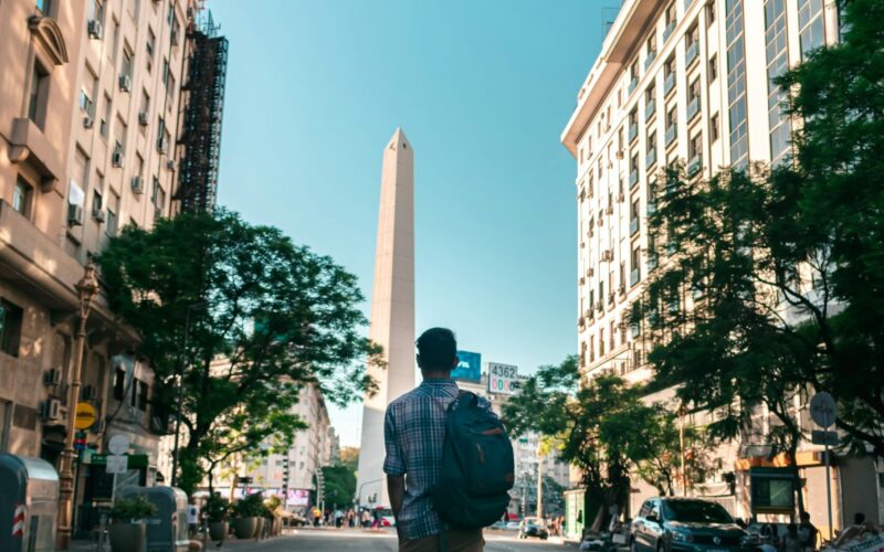 A young man walks down an empty street in Buenos Aires towards the famous Obelisk. Building your ideal study abroad experience means going deep in local relationships.